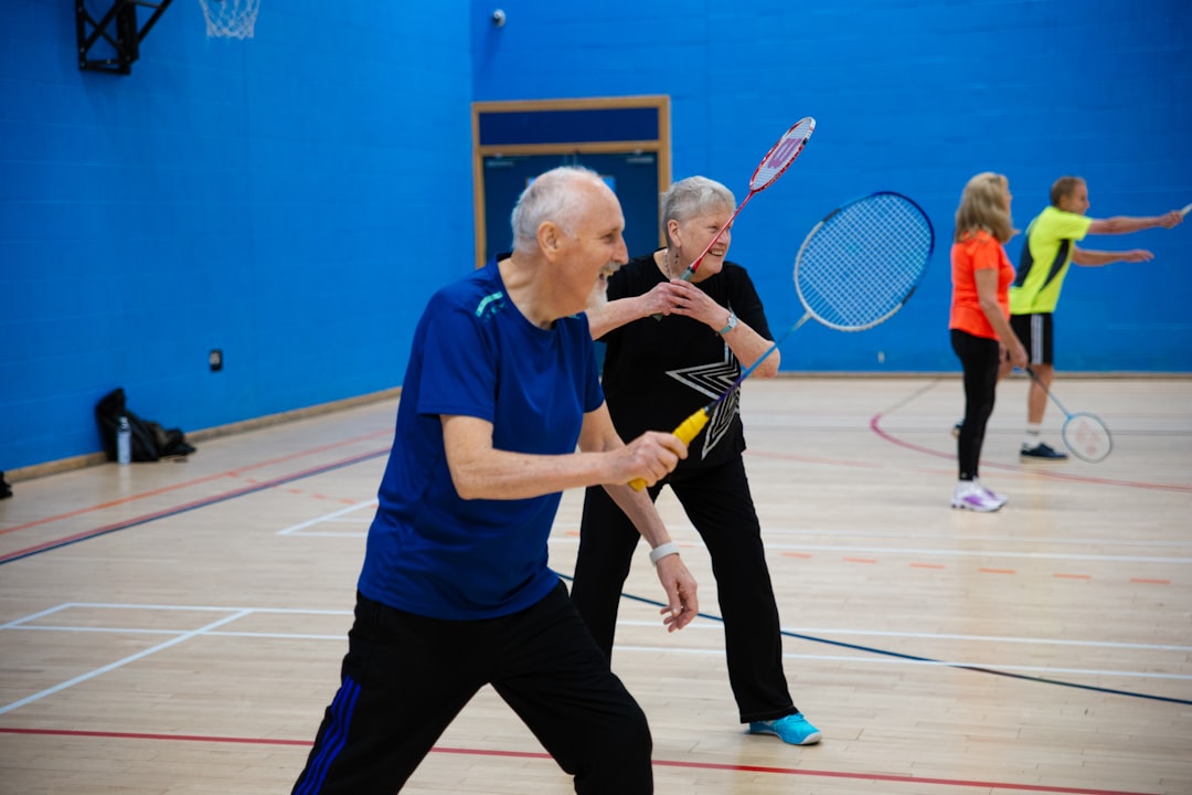 seniors-playing-badminton-in-a-gymnasium-4gny9e-ybfm